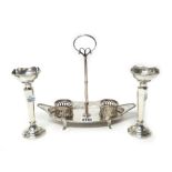 A Victorian silver twin bottle boat shaped cruet stand, with pierced decoration,