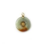 A gold and jade circular pendant with a Chinese character to the centre, diameter 2.