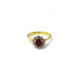 An 18ct gold, ruby and diamond set eleven stone cluster ring,