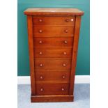 A Victorian oak Wellington chest, with seven graduated drawers enclosed by locking bar,