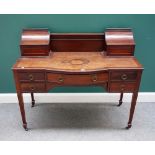 A late 19th/early 20th century mahogany Carlton House style desk on tapering square supports,