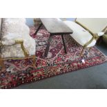 A Bakhtiari carpet, Persian, the madder field with a bold lozenge medallion,