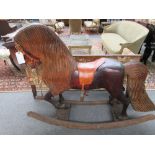 A stained and carved pitch pine rocking horse, adult size, late 20th century,