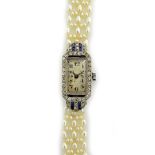 A lady's platinum cased, diamond and synthetic sapphire set dress wristwatch,