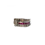 A ruby and diamond set cocktail ring, in a curved design, mounted with a row of calibre cut rubies,