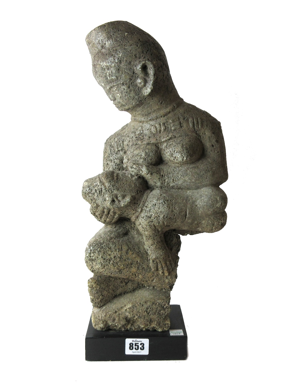 A Kongo stone fertility figure, modelled as a mother breast feeding a child,