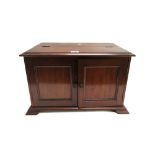 A 19th century mahogany table top cabinet, with lift top and pair of doors, on pointed bracket feet,