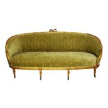 A 19th century French gilt framed tub back sofa, with ribbon tied crest on reeded supports,