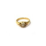 A gold and diamond set single stone ring, claw set with a circular cut diamond, detailed 18 CT,