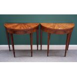 A pair of George III style inlaid mahogany demi lune card tables, on tapering square supports,