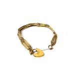 A gold bar and oval link gate bracelet, on a gold heart shaped padlock clasp, detailed 9 CT,