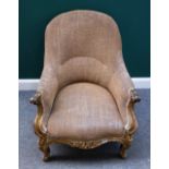 A Victorian gilt framed tub back armchair, with serpentine seat and scroll supports,