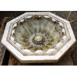 A 20th century carved marble octagonal planter, relief carved with a lotus flower,