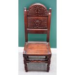 A 17th century Lancashire carved oak panel back single chair, on block and turned supports,