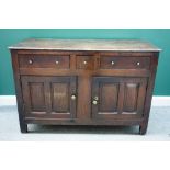 An early 18th century oak dresser base, with three drawers over a pair of double panel cupboards,