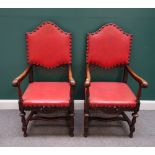 A pair of 17th century style oak framed open armchairs, on turned supports,