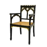 A Regency Gothic Revival ebonised parcel gilt open armchair,