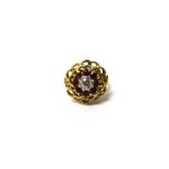 A gold, diamond and ruby nine stone cluster ring, pierced in an abstract design,