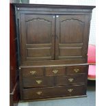 A mid-18th century oak bacon cupboard, with pair of shaped panel doors over six various drawers,