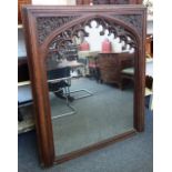 A Victorian Gothic Revival oak framed wall mirror, with pierced arch decoration,