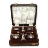 A silver six piece condiment set, comprising; two mustard pots, with blue glass liners,