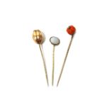 A gold stick pin, with a melon fluted coral bead terminal, a gold stick pin,