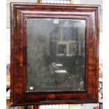 A 17th century and later figured walnut rectangular cushion framed wall mirror,