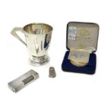 A silver christening mug, with an angular handle, Sheffield 1910, a silver thimble, Chester 1891,