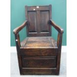 A George III oak box seat panel back open armchair, 56cm wide x 97cm high.