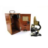 A brass lacquered and ebonised microscope by E.