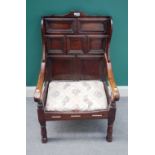 A Charles II and later panelled wing back open armchair, on turned supports, 63cm wide x 101cm high.