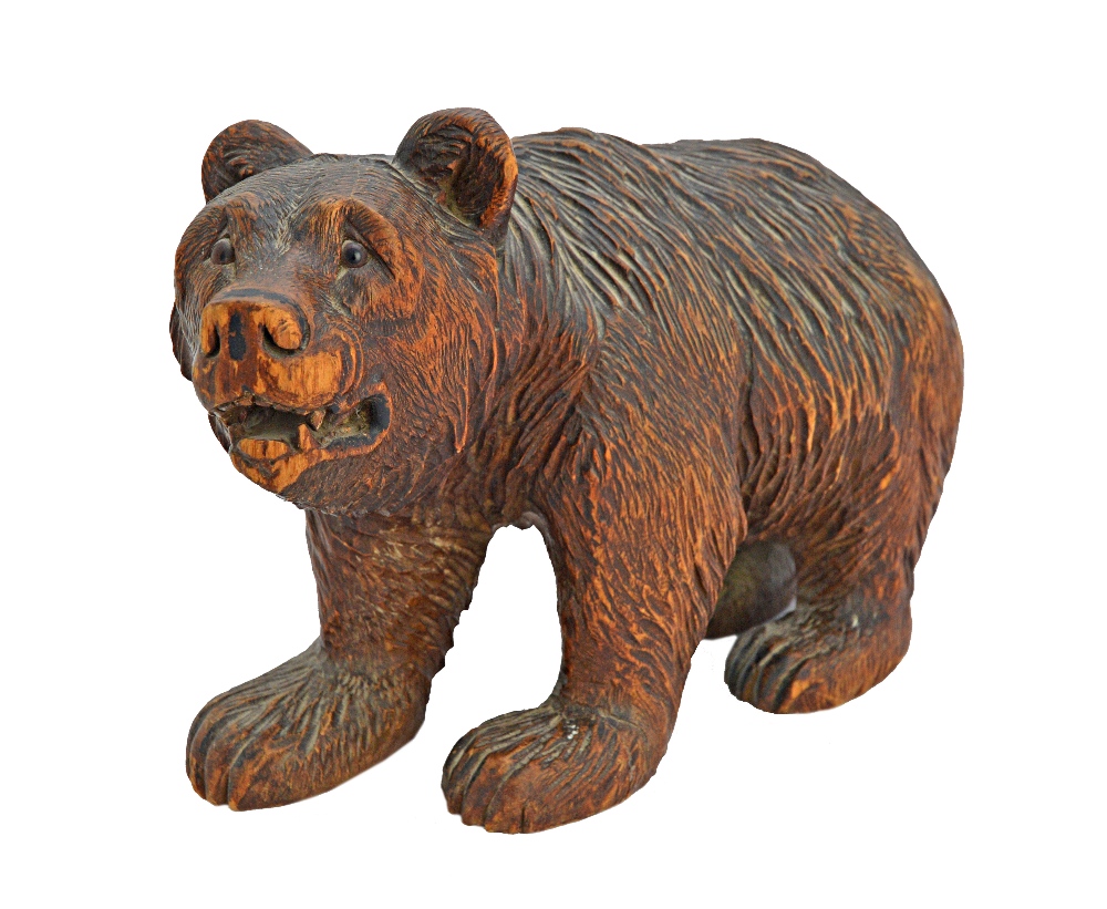 A Black Forest carved wooden bear, early 20th century, with glass eyes and open mouth,