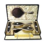 A lady's silver mounted tortoiseshell five piece dressing set, comprising; a hand mirror,