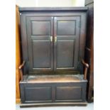 An 18th century Welsh cupboard back oak open arm box seat settle/bacon cupboard, on plinth base,