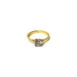 An 18ct gold and diamond set single stone ring, claw set with a circular cut diamond,