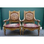 A pair of late 19th century gilt framed open armchairs, with serpentine seat and fluted supports,