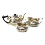 Silver, comprising; a matched three piece tea set, comprising; a teapot, Birmingham 1902,