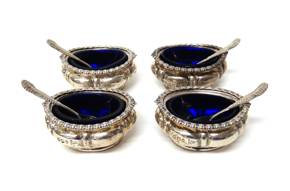 A set of four late Victorian silver salts, each of oval form with decorated rims, by Walker & Hall,