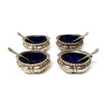 A set of four late Victorian silver salts, each of oval form with decorated rims, by Walker & Hall,