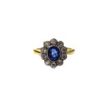 A gold, diamond and sapphire set eleven stone oval cluster ring,
