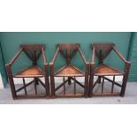 A set of three Arts and Crafts oak turner's corner chairs, of 16th century design,