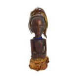 A Luba torso, Democratic Republic of Congo, wood, hide, hair and blue glass beads, 32cm high.