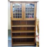 An early 20th century oak bookcase in the Liberty manner,