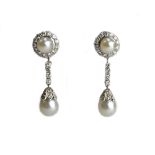 A pair of diamond and cultured pearl pendant earrings, each with a cluster top,