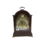 An Elliott mantel clock, with Westminster three train movement, in a mahogany case, on brass feet,