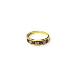 An 18ct gold, diamond and treated ruby seven stone ring,