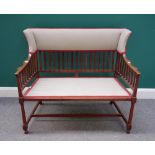 An Edwardian mahogany wingback small settee, with padded top rail above slat filled back and arms,