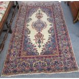 A Kerman rug, Persian, the ivory field with a central floral medallion,