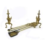 A set of 19th Century brass fire dogs and three matching fire irons with baluster and lobed finials,