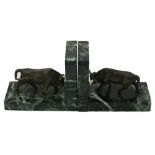 A pair of verde antico marble bookends, 20th century, each surmounted by a bronze figure of a bull,